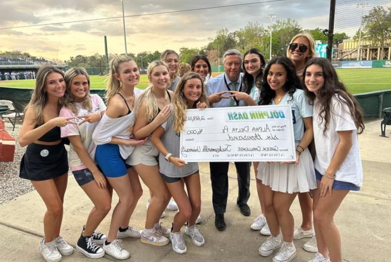 President Tim Cost posing with Greek Challenge Winners at Dolphin Dash