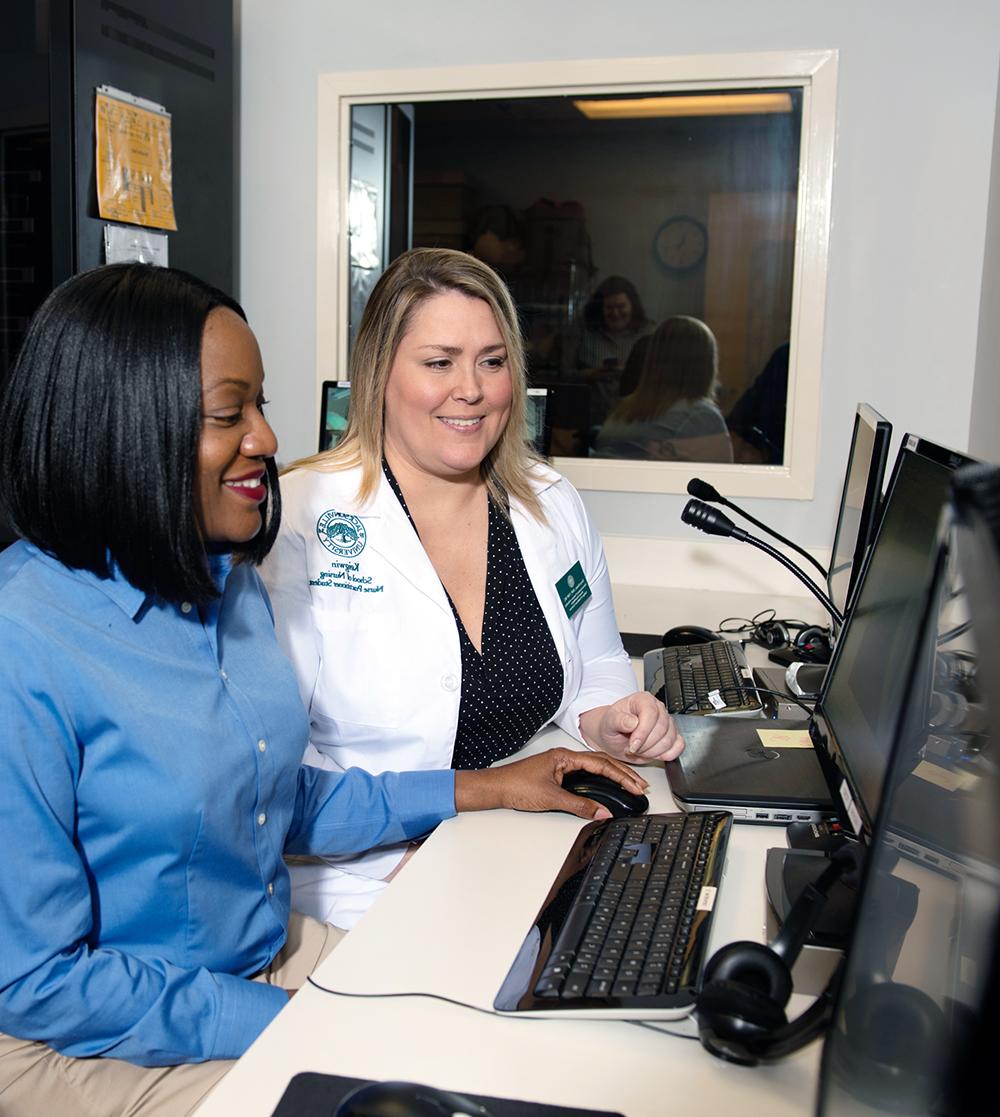 A team of healthcare professionals working on the computer.